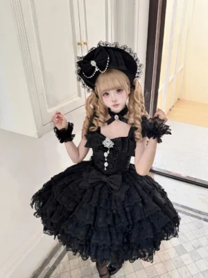 Black sweet lolita jumper skirt dress with multi-layered lace ruffled skirt, gem brooch neckline detail, pearl ornament lace bonnet, blonde twin-braids - front full body view