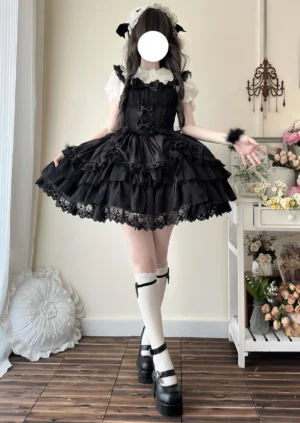 Black sweet lolita jumper skirt dress with multi-layered tulle skirt and lace hem, sleeveless fitted bodice, paired with platform mary jane shoes and lolita styling side-front angle
