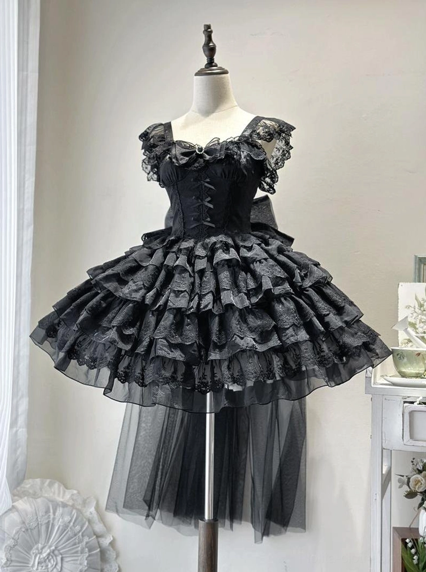 Black sweet lolita JSK jumper skirt on mannequin displaying ruffled shoulder straps, lace-trimmed neckline, layered tiered tulle skirt with back train