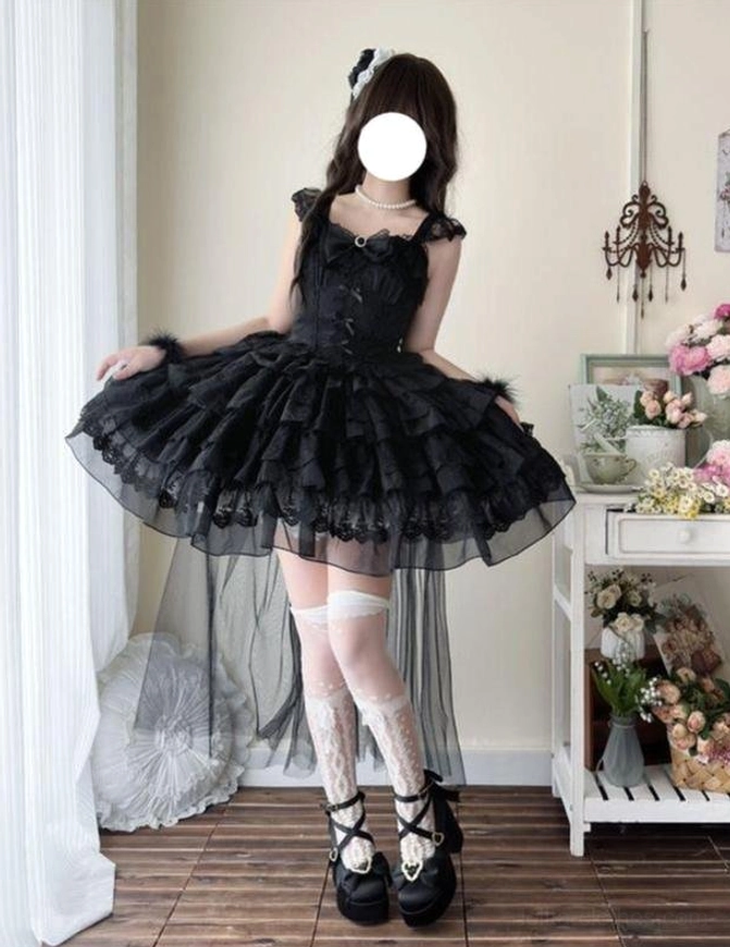 Black sweet lolita JSK dress with ruffled shoulder straps and layered tiered tulle skirt with side tulle train, front three-quarter view