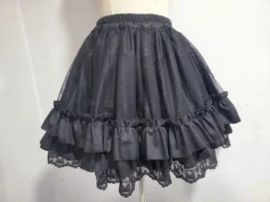 Black sweet lolita underskirt petticoat front view on dress form showing elastic waistband double-layered ruffled hem with lace trim and sheer mesh outer layer