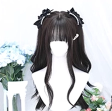 Long black tea wavy Lolita wig back view on mini mannequin showing pearl-adorned black bow hairpins on top back, natural wavy dark hair texture and vintage floral background
