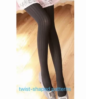 Black twist-patterned jacquard lolita pantyhose on female legs with lace skirt and grey flats indoor wooden floor