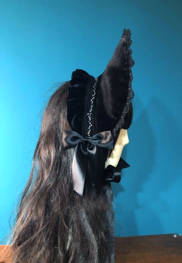 Black velvet gothic lolita bonnet rear view showcasing large satin back bow, beaded decorative stripe on back panel and scalloped lace edge finishing