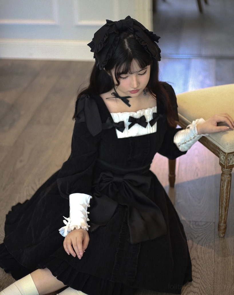 Black velvet Lolita OP dress styling detail showing how to layer removable white chest cover-up and detachable cuffs for different aesthetic variations and occasion versatility