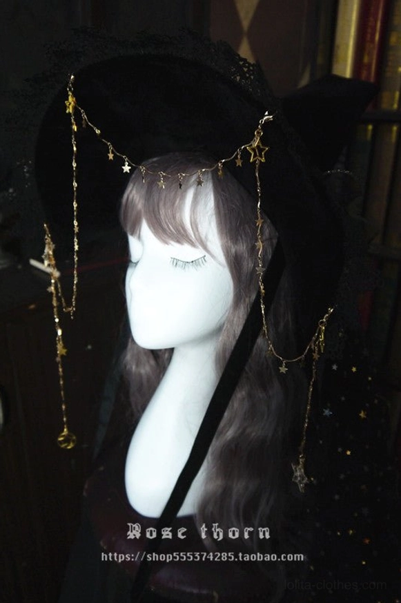 Front close-up display of black velvet lolita witch hat with gold forehead hanging star chain ornaments and delicate metal tassels on mannequin