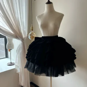 Black velvet tiered Lolita skirt side view on dress form displaying fluffy multi-layered ruffle structure and soft velvet fabric texture with window backdrop