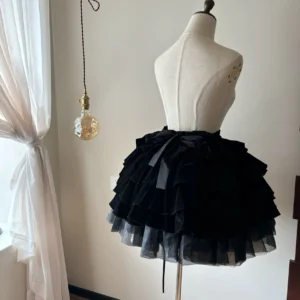 Black velvet tiered Gothic Lolita short skirt rear three-quarter view on dress form showing layered cake silhouette satin bow and tulle underskirt detail