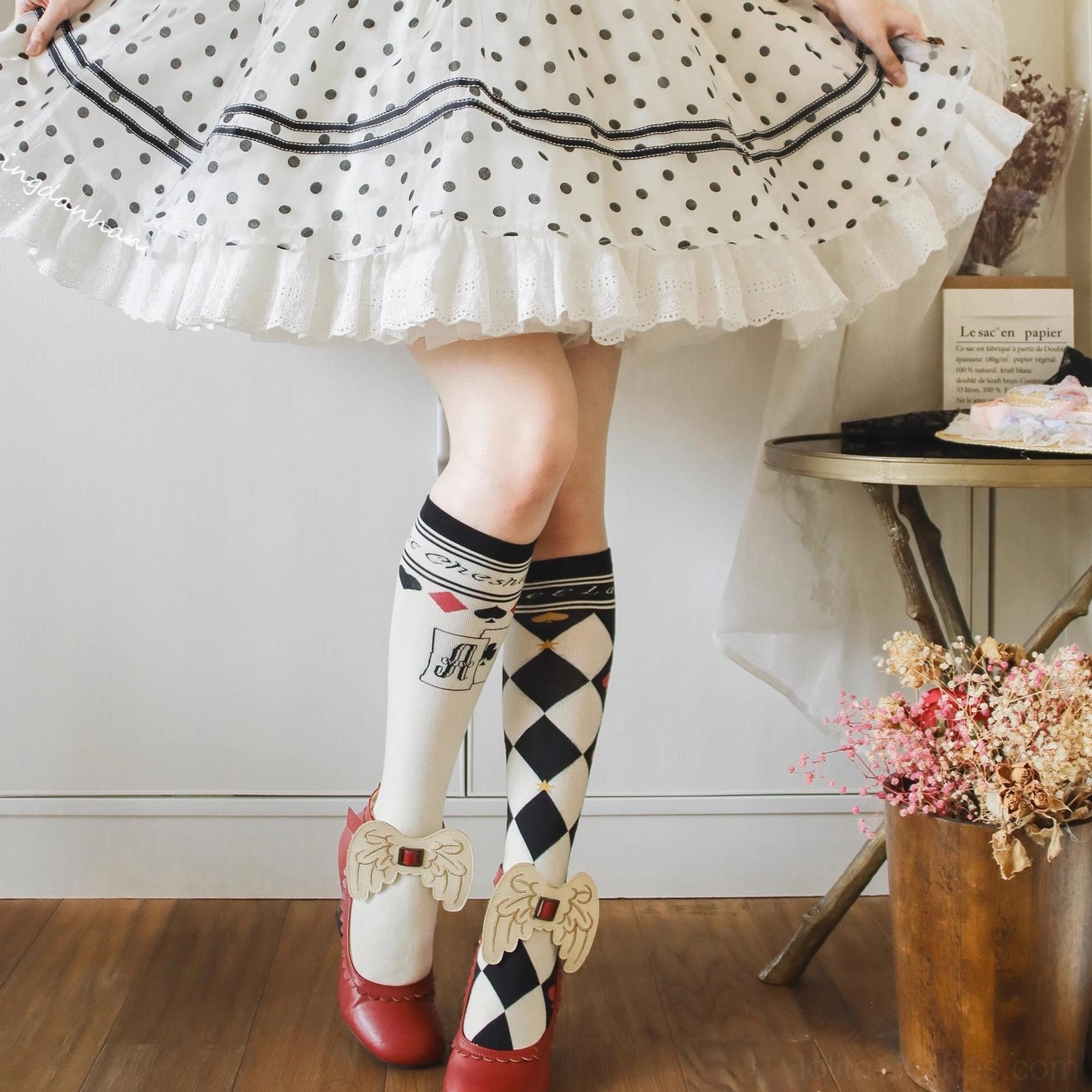 Black and white checkerboard poker card asymmetrical lolita cotton socks close up foot wear view with patent leather shoes