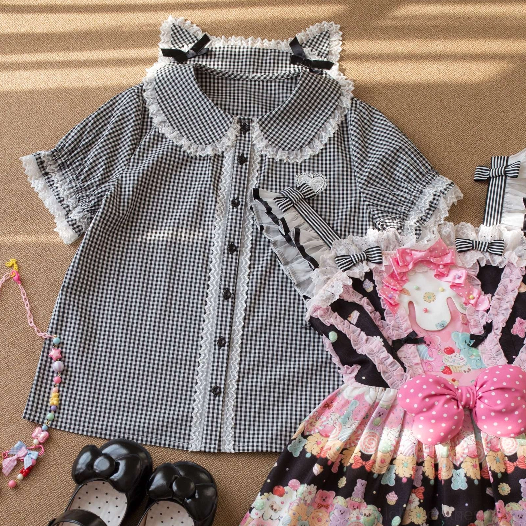 Black and white gingham Lolita blouse with cat ear collar, lace trim and black bows, styled with black sweet print jumperskirt and beaded accessories