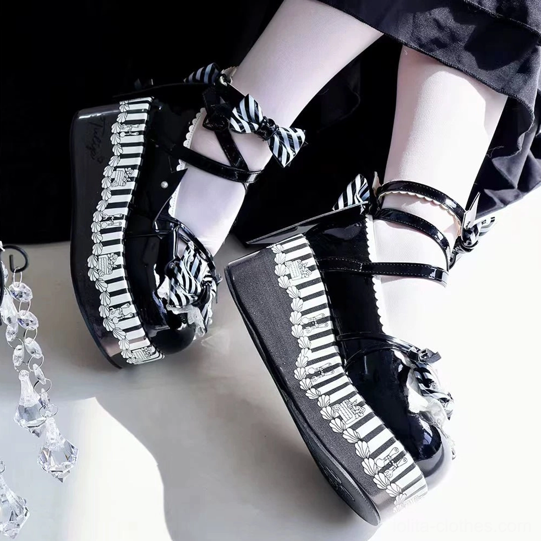 Black and white gothic lolita platform Mary Jane shoes with patent leather upper, striped decorative trims, bow ankle straps, ultra thick platform sole with printed white thigh highs