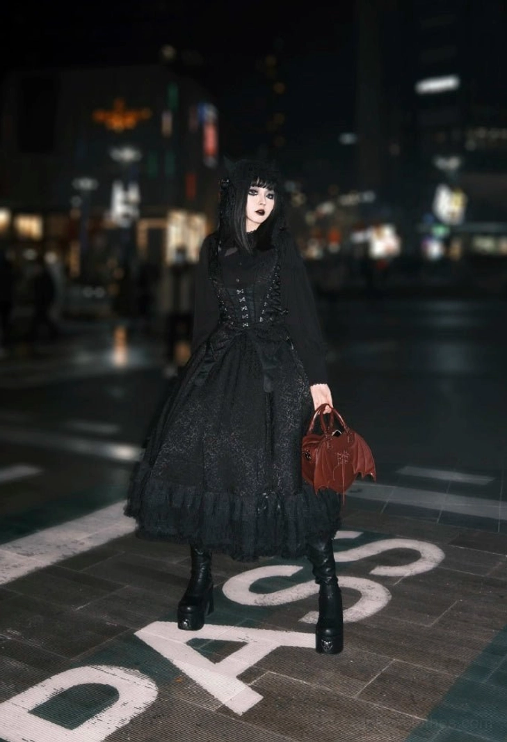 Black and white gothic lolita vest variant showing contrasting skeleton-pattern corset trim decoration, dual-color aesthetic, corset side lacing detail, and butterfly-themed hemline