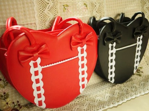 Black and white heart-shaped Lolita tote bag front view with bow accents ruffled ribbon detail