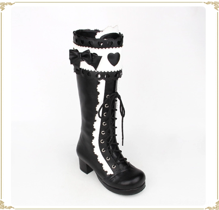 Black and white lolita mid-calf thick heel boots left three-quarter single shoe view displaying side profile and decorative front lace-up