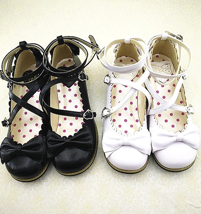 Two pairs of Lolita low heel princess shoes in black and white color options, featuring cross buckled ankle straps, front bow decorations, polka dot inner soles, and scalloped trims