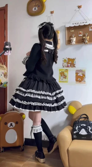 Black and white classic lolita full outfit back view with long-sleeve black top layered ruffle lace skirt and knee-high socks