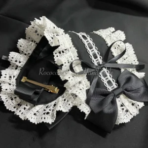 Black and white lolita rococo headband with hollow lace trim and satin decorations top-down flat lay