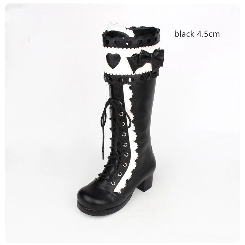 Black and white lolita mid-calf boots with 4.5cm heel labeled single shoe front flat view showing lace system and heel structure
