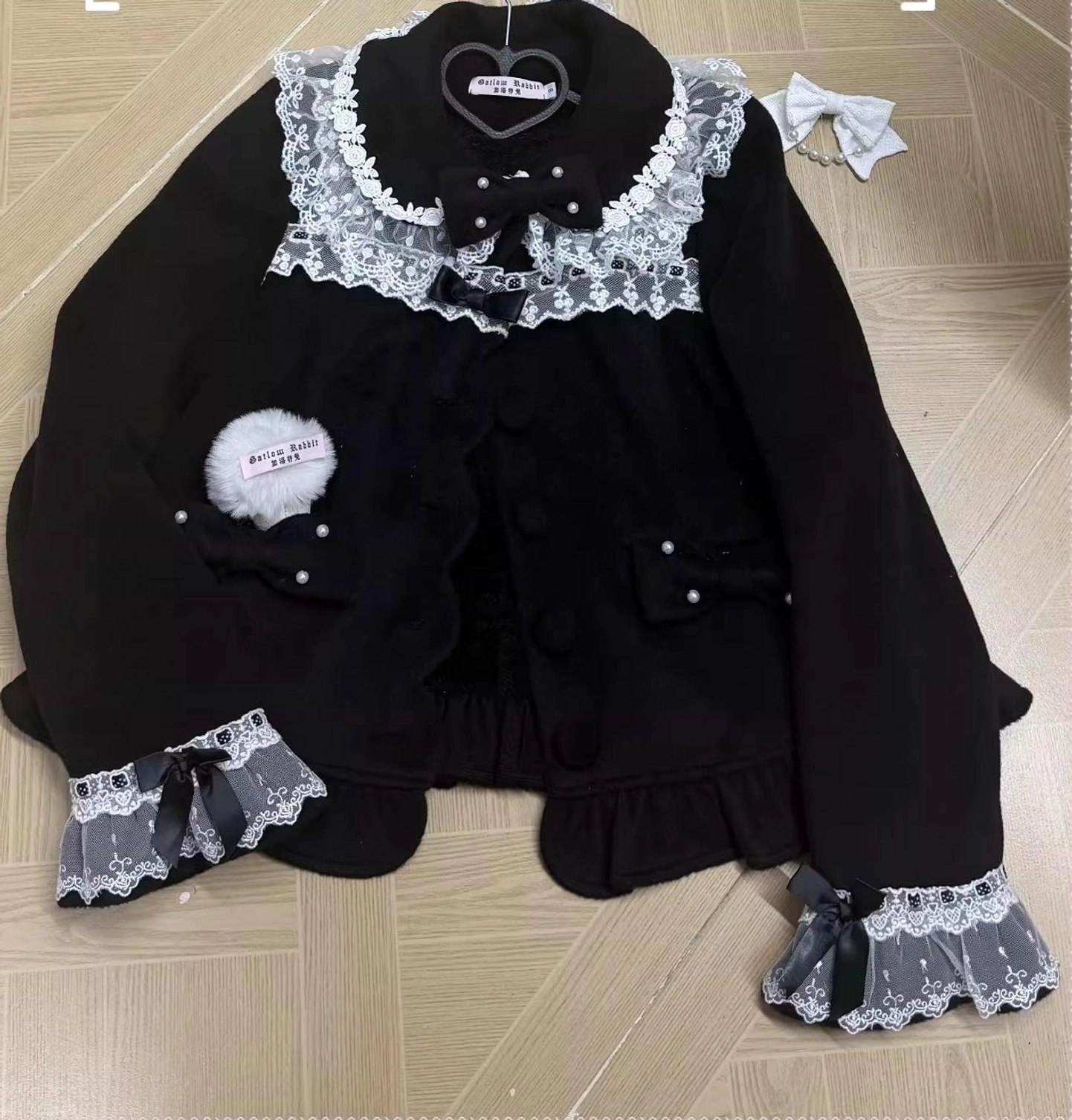 Black and white lolita wool coat front static display showing structured silhouette peter pan collar lace detailing and button closure