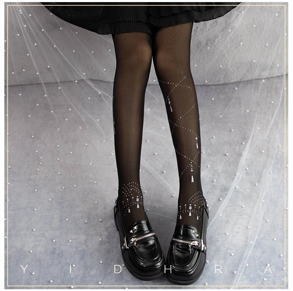 black white song and lights lolita tights with silver light star patterns and tassel prints paired with black buckle leather mary jane shoes and black mini skirt front view