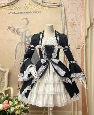 Black and white old school lolita OP dress with front lace-up bodice and layered ruffled cake skirt displayed on dress mannequin in vintage boutique setting