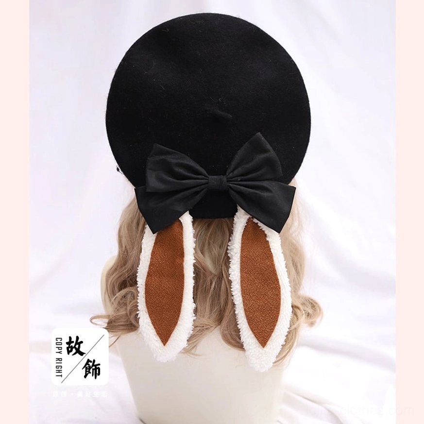 Black wool lolita beret with beige fuzzy trimmed bunny ears and black satin bow - rear flat lay display