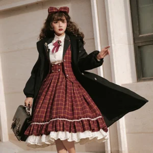 Black wool Victorian cape coat with lapel detail worn by lolita model in front of European residential building, showcasing full-length silhouette and refined tailoring