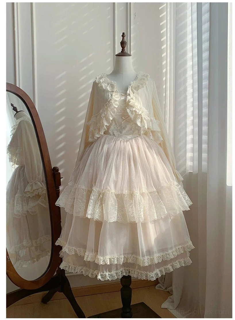 Beige short lolita jumperskirt with lace ruffle bodice and layered tulle cake skirt with lace hem, three-quarter view on dress mannequin in studio