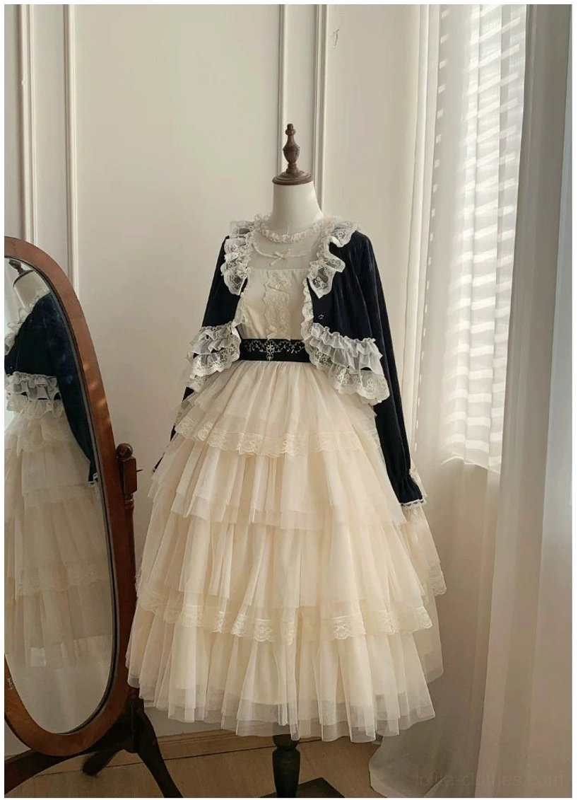 Lolita two-piece floor-length coordinate set with black cropped lace-trimmed bolero, full-length beige tiered tulle skirt and fitted waist belt, side-front view