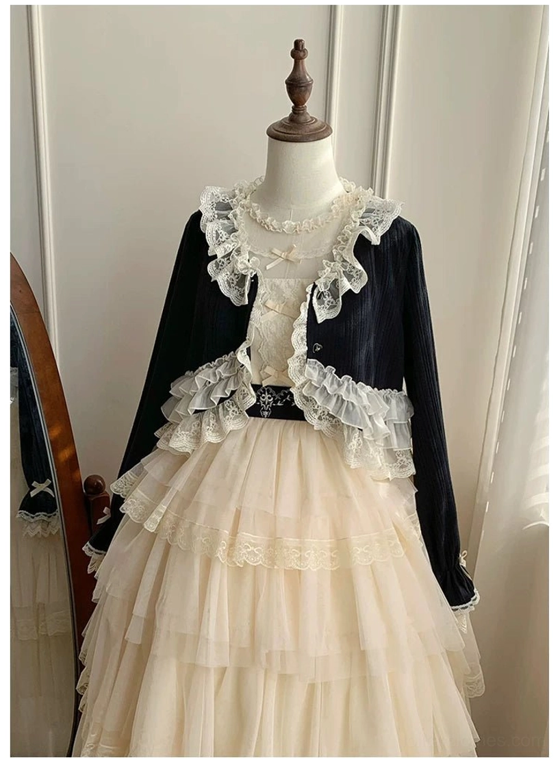 Lolita two-piece floor-length coordinate featuring black cropped bolero with elaborate lace trims, beige tiered tulle skirt with decorative waist belt and buckle