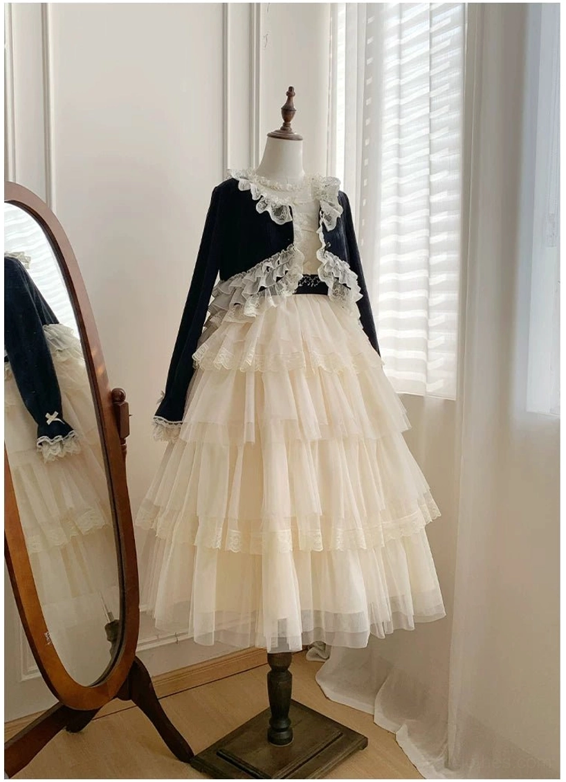 Lolita two-piece short skirt coordinate with black knit bolero featuring lace frills and short beige tiered tulle skirt, side profile view on dress mannequin