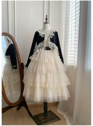 Elegant lolita two-piece coordinate set featuring black cropped lace-trimmed bolero with beige tiered tulle skirt, front full view on dress mannequin in studio setting