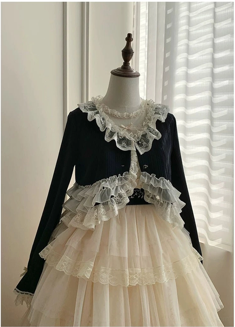 Close-up detailed view of lolita cropped bolero showing intricate lace collar and ruffle trims on black fabric with layered tulle skirt and lace trim