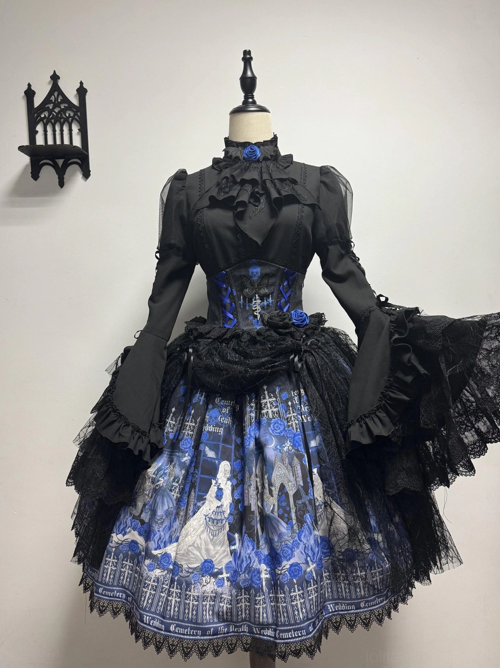 Blue Blood Wedding Gothic Lolita complete dress set front view - featuring black corset top with flared ruffled long sleeves, blue and white gothic castle printed skirt with lace hem, mannequin display