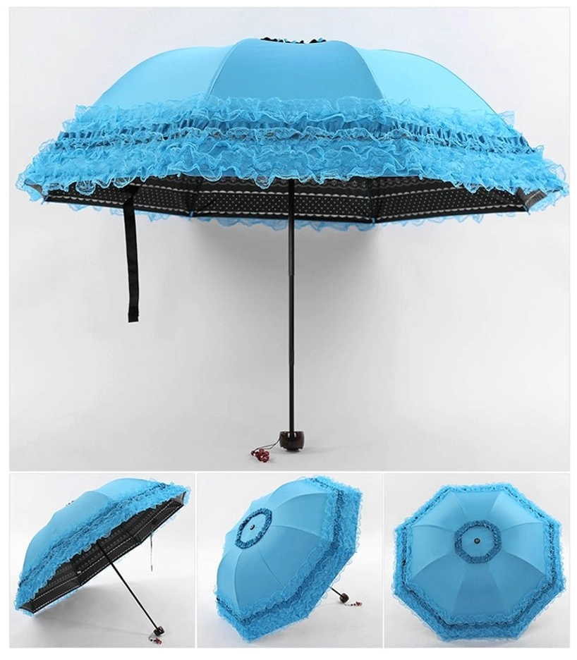 Blue foldable parasol with botanical printed canopy displayed in flat lay composition with fashion magazine and coordinated styling elements