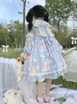 Blue sweet lolita OP dress featuring all-over bunny cloud print pattern, back view showing detachable bunny ear shoulder decoration, layered ruffled hem, white lace trim details, and structured A-line silhouette