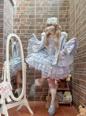 Blue bunny ear hooded kawaii lolita cape with ruffled puff sleeves and double-layer ruffled hem styled with gradient blue frilly lolita dress mirror fitting view