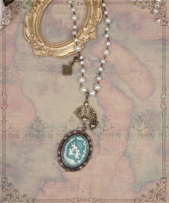 Blue cameo lolita pearl necklace bronze filigree metal tag charm vintage gold frame backdrop flat lay