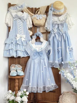Blue gingham sweet lolita JSK dress collection display with matching daisy bow blouse, straw hat, headband and woven basket on wooden retro backdrop