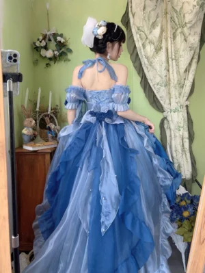 Blue off-shoulder Lolita trailing dress with halter neck design and layered ruffled trailing hem featuring delicate rose decorations and waist bow