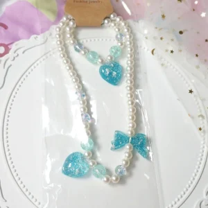 Blue heart charm gradient pearl choker and matching bracelet lolita accessory set on decorative white lace tray