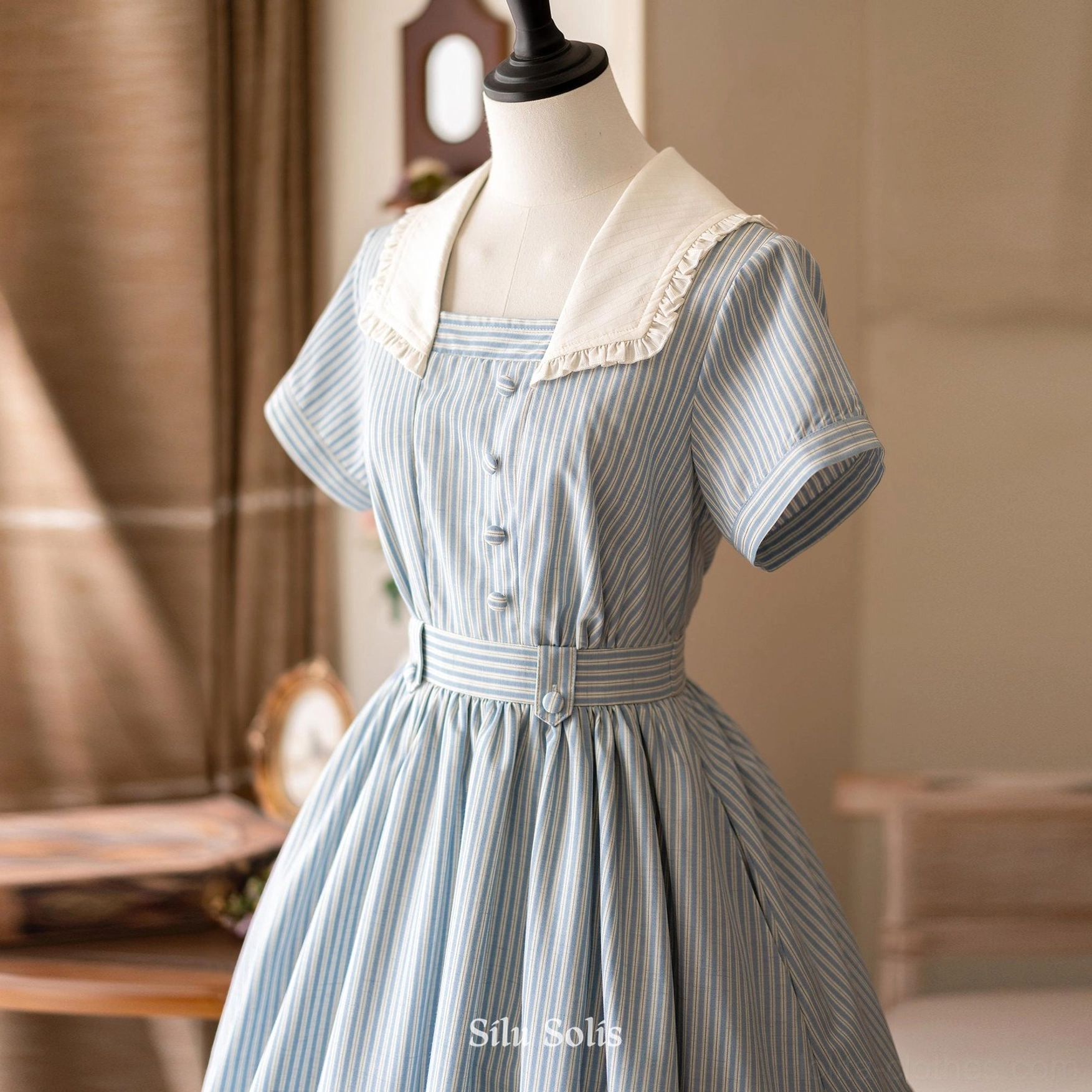Front medium close-up of blue striped classic Lolita dress showcasing square neckline with ruffled sailor collar, puffed short sleeves, and fitted front bodice buttons