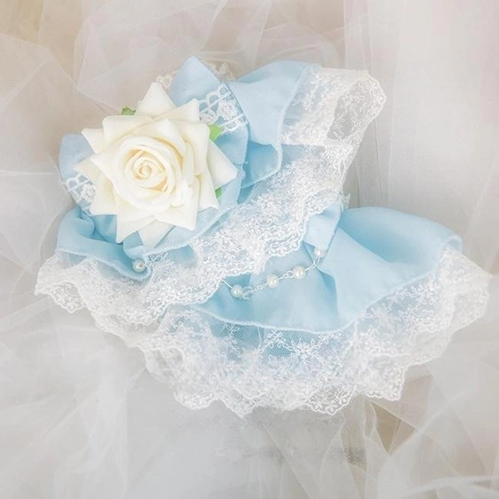 Flat lay product photography of blue Lolita wrist cuff pair with rose decorations and pearl beads for sweet Lolita fashion coordinate styling