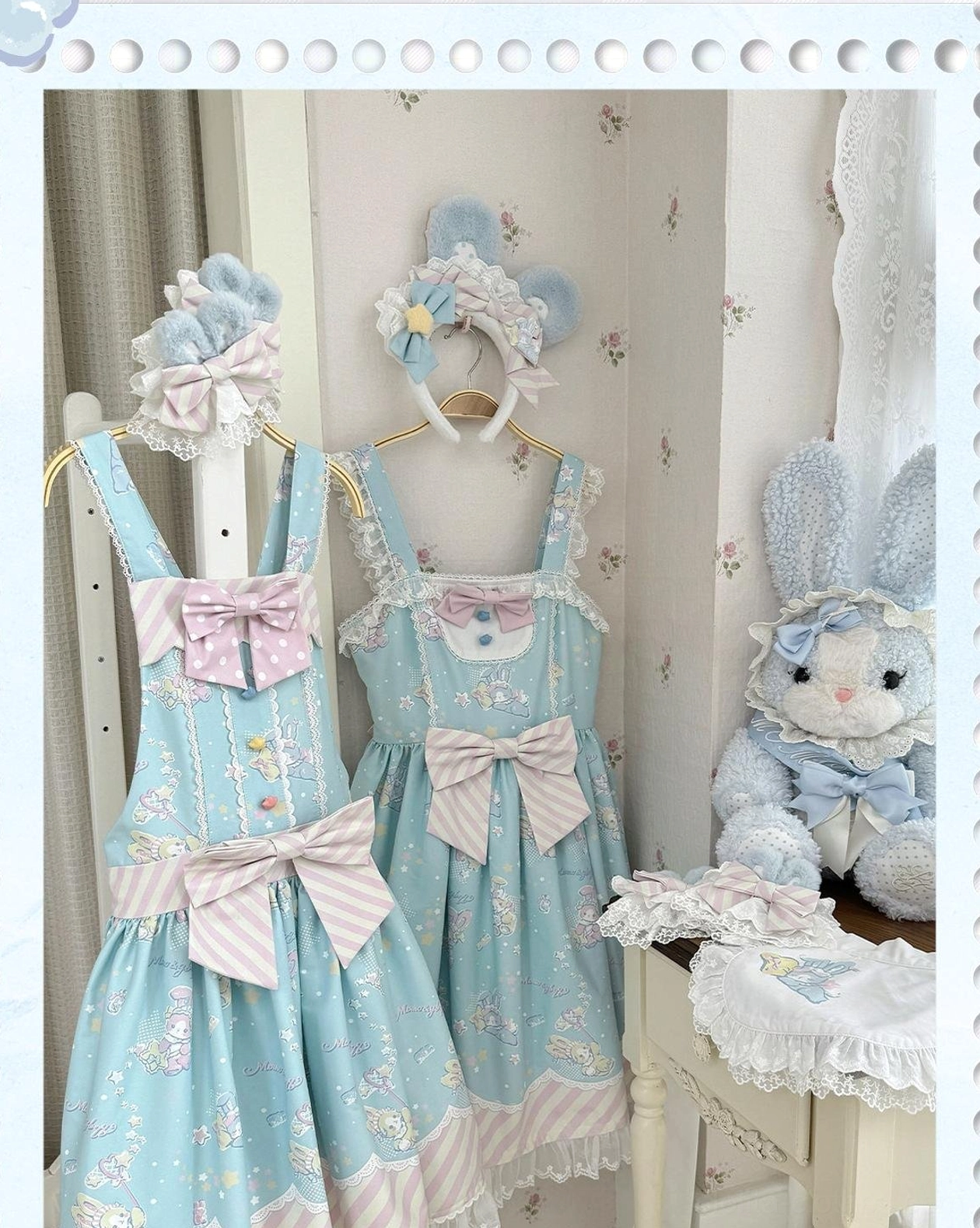 Front hanging display view of blue pastel Lolita jumper skirt with matching bunny ear headwear, striped bowknot waist decoration, delicate lace trim, star and bunny pattern details in vintage indoor room with plush rabbit toy