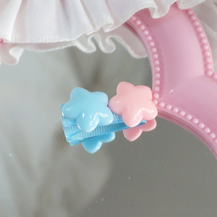 Blue and pink double star hair clip with bright pastel beads and blue fabric-covered metal clip base side view