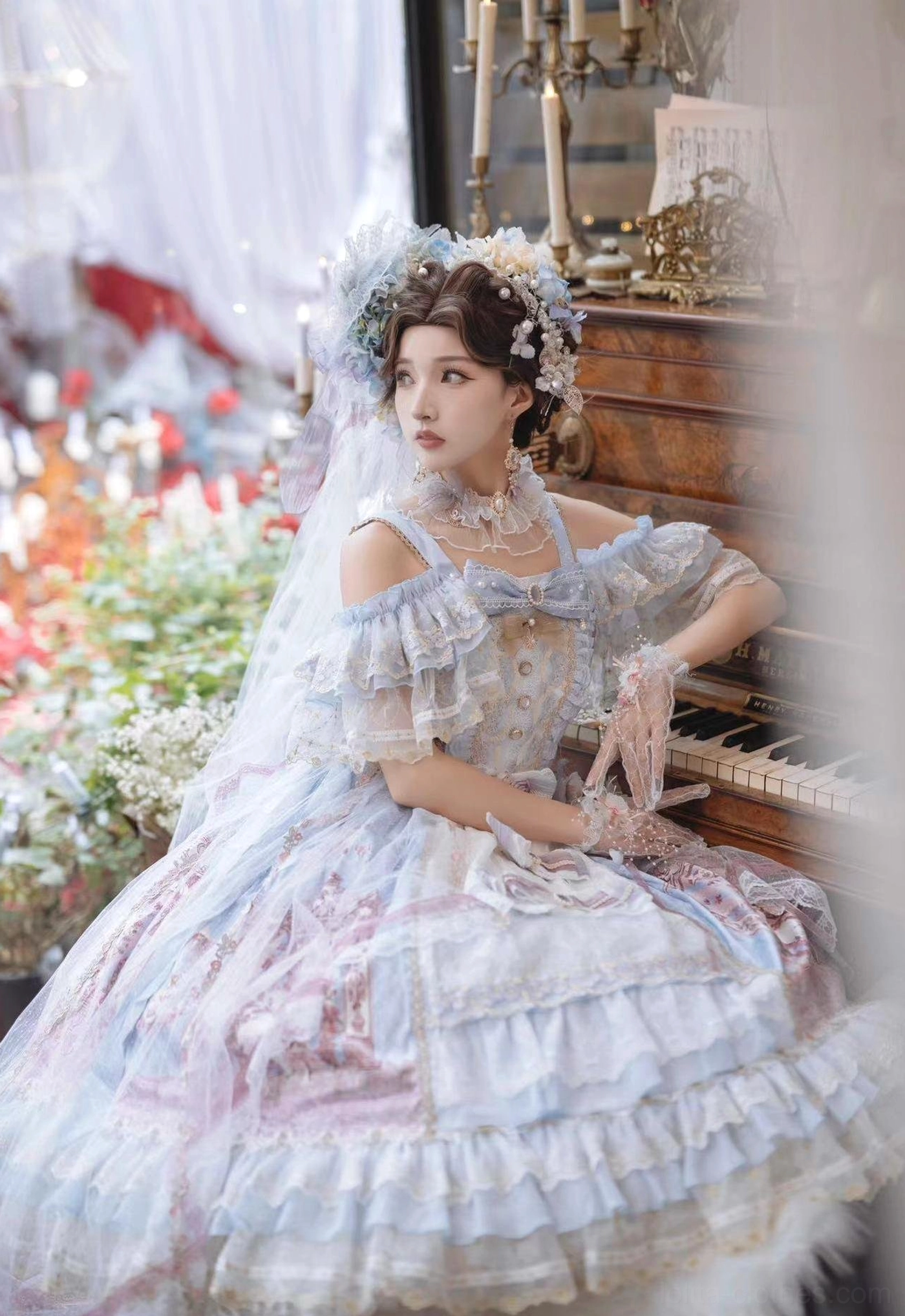 Blue-pink gradient wedding Lolita JSK dress with off-shoulder ruffled sleeves and square neckline bow trim, model with floral headpieces beside vintage piano