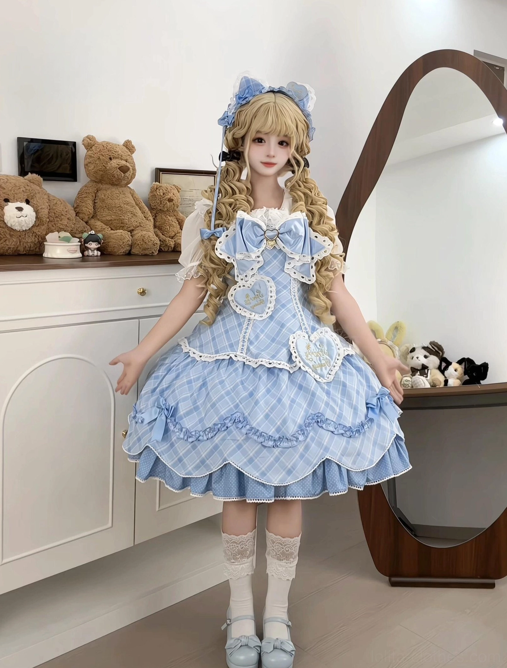 Blue plaid sweet lolita JSK jumper skirt dress front full-body single model view with blue-and-white gingham pattern, large back detachable waist bow, lace trim and heart decoration details, white stockings light blue flat shoes and bunny ear headpiece in vintage bedroom setting