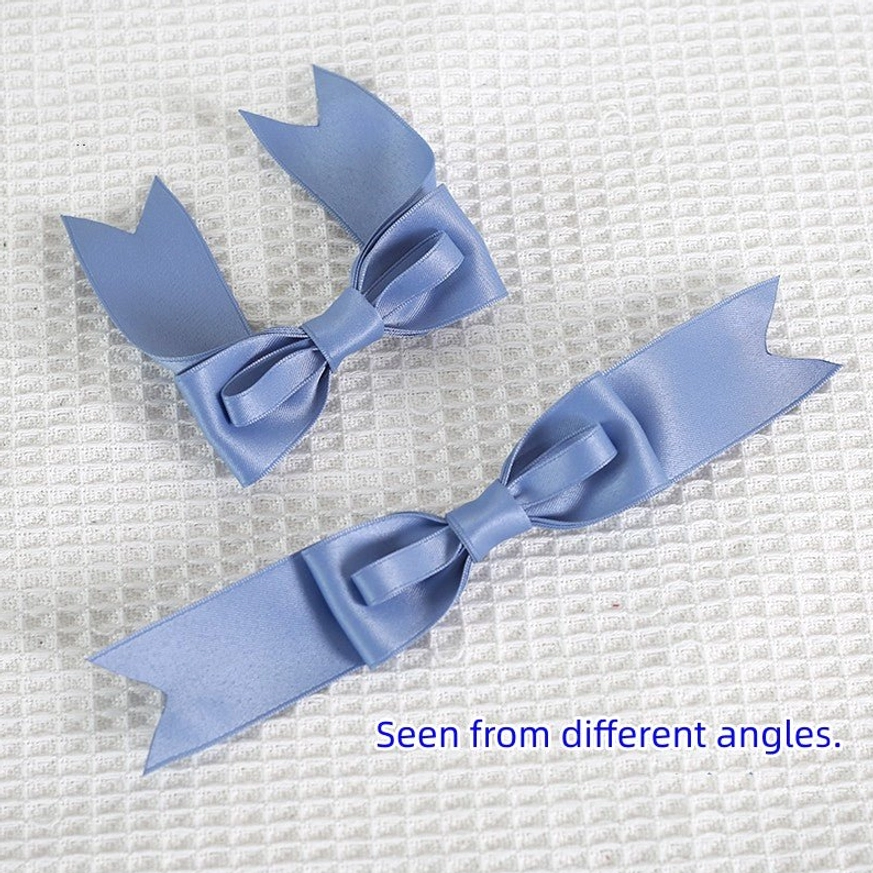 Blue glossy satin bow hair clips showing different angles and two sizes of bow designs flat lay product photography