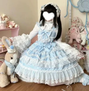 Blue sweet wedding lolita JSK dress with inner blouse sitting side view showcasing tiered lace skirt and puffed sleeves in cozy vintage room