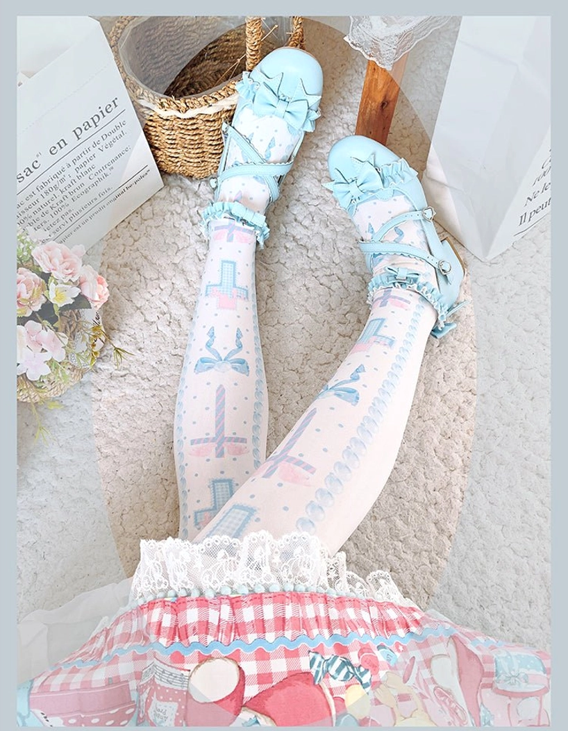 Side lower-body view of blue and white lolita thigh high stockings with bow cross prints, paired with gingham pink lolita dress